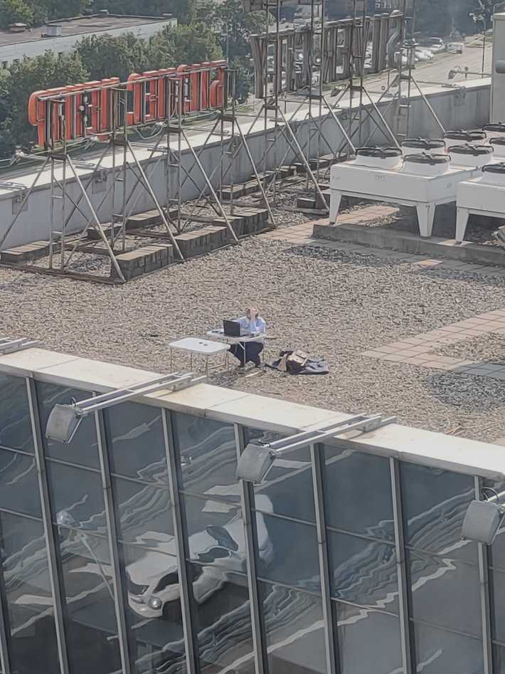 A man is working next to my office. Full social distancing!