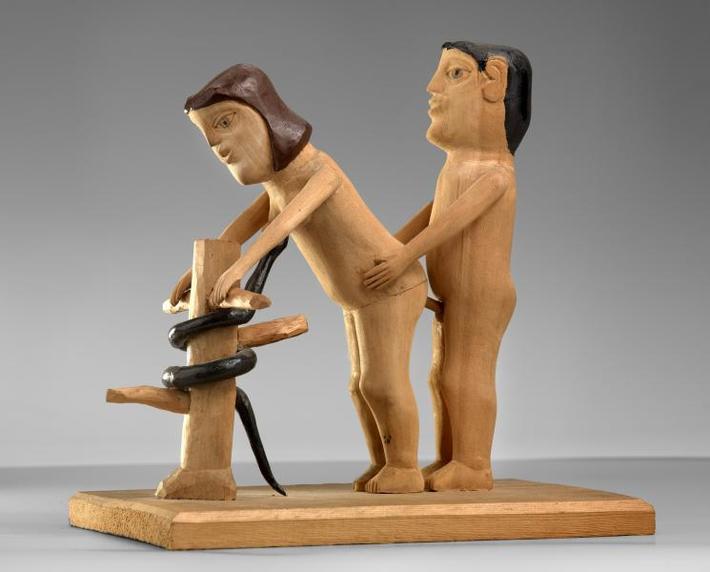 This is a wooden piece of Adam and Even displayed at the Smithsonian Art Museum