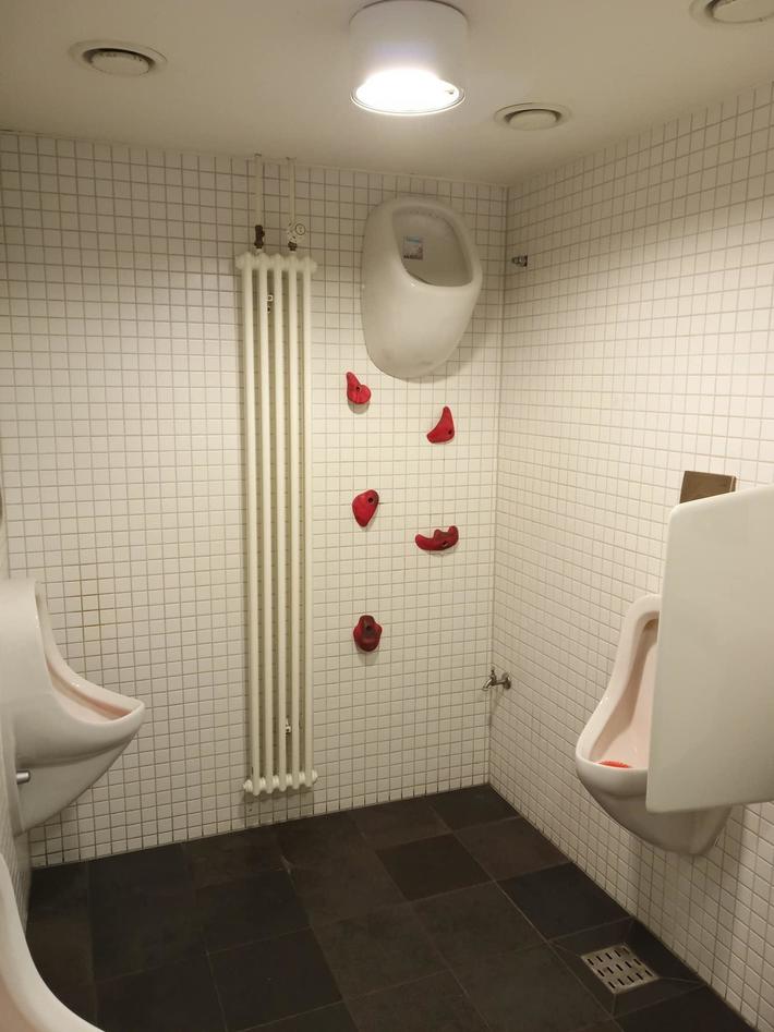 Men’s bathroom inside a rock climbing gym