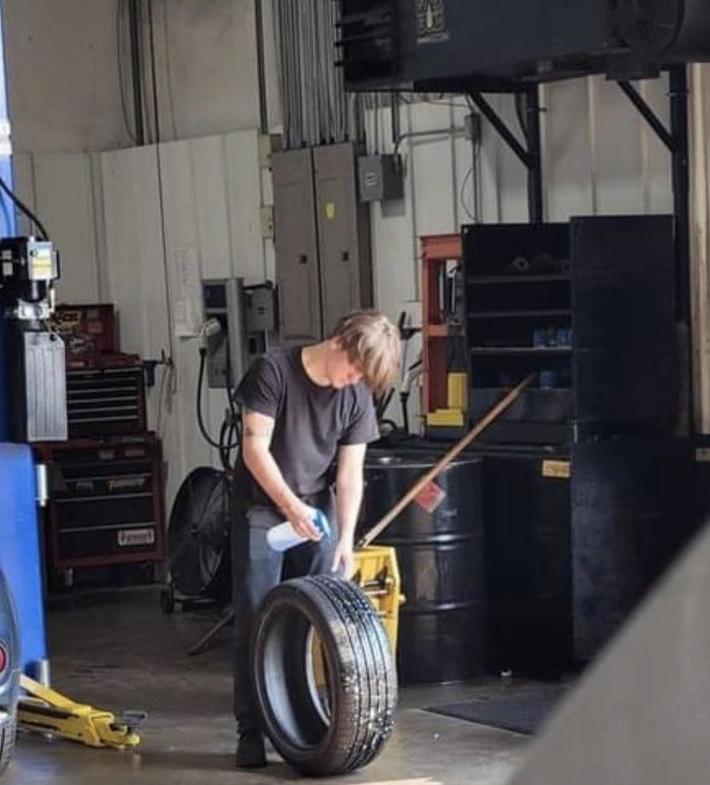 Newbie attempting to check a tire for an air leak.